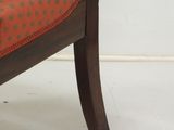 an image of a chair with a red upholstered seat on a white floor