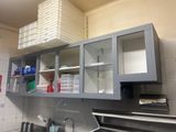 a kitchen with a sink, cabinets, and a stove