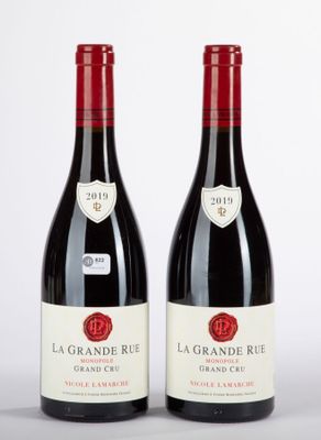 two bottles of red wine sitting next to each other on a table