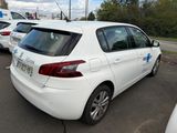a white car parked in a parking lot with other cars