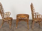 three chairs and a table in a room with a white wall