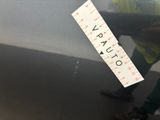 a man standing next to a car with a ruler on it ' s side