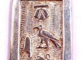 an image of a silver pendant with a bird and a bird on it