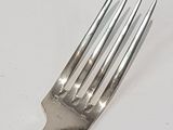 a fork that is sitting on a white table