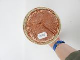 a person holding a bowl of food with a label on it