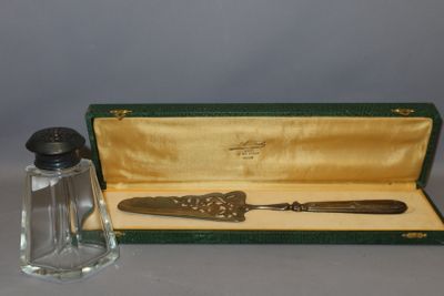 a glass bottle and a metal spoon in a case