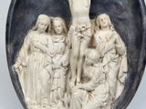 a statue of jesus on the cross in the middle of a group of people