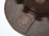 a close up of a metal object on a white surface