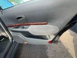 the door of a car with the driver ' s door open