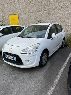 two small cars parked in a parking lot next to each other