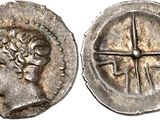 a silver coin with an image of a woman and a cross on it