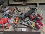 a pile of tools on a pallet in a garage