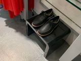 a pair of shoes sitting on a glass shelf in a bathroom
