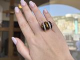 woman ' s hand with two rings on her left and a ring on her right hand