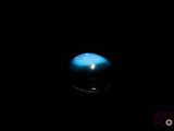 an image of a blue ball in the dark with a black background