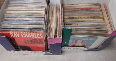a lot of vinyl records in a box on the floor