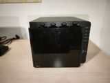an image of a black microwave on a wooden table