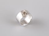 a close up of a silver ring with a knot in the middle