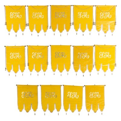 a close up of a number of yellow pennants hanging on a wall