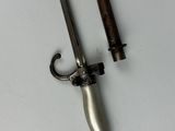 two swords that are laying on a white surface