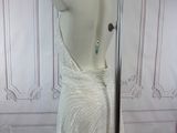 a dress on a mannequin stand in front of a wall