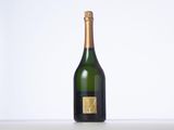 an empty bottle of champagne on a table with a white background