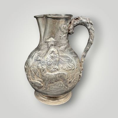 an image of a silver vase with a woman and a man on it