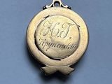 an image of a gold medal with the word god on it