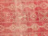 a close up of a red rug with a pattern on it