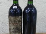 deux bouteilles de vin posées sur une table l'une à côté de l'autre