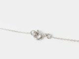 a close up of a silver chain with a heart on it