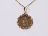 an image of a gold necklace with a picture of the virgin of guadalupe