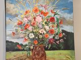 une peinture de fleurs dans un vase sur un chevalet