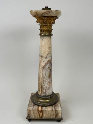 an image of a marble pedestal with a lamp on top