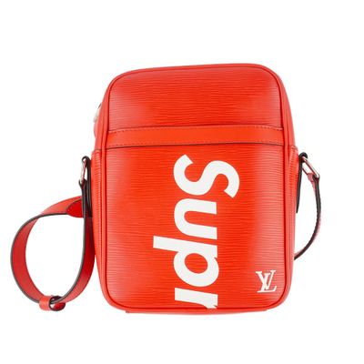 a red bag with a white supreme logo on it