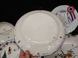 a person holding a white plate with a blue ribbon on it