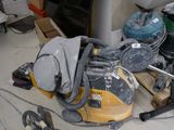 a yellow and black vacuum sitting on the floor