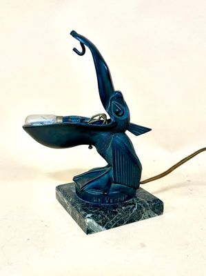 a blue statue of a bird with a hook on it ' s head