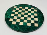marble chess board with green and white squares on a white surface