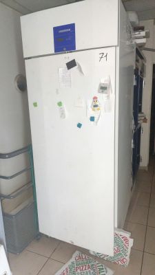 an image of a refrigerator in a kitchen with papers all over it