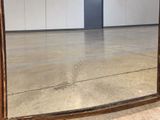 a mirror that is sitting on the floor in a room