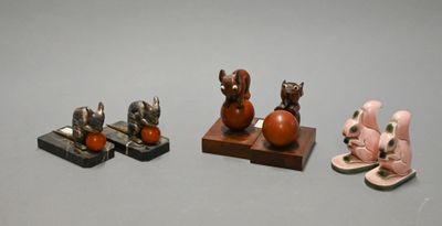 three figurines of animals sitting on top of a table