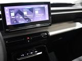 the interior of a car with a touch screen and a steering wheel