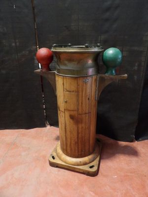 a wooden stand with a metal pot on top of it
