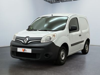 the small white van is parked in a large room