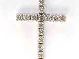 a diamond cross pendant on a white background