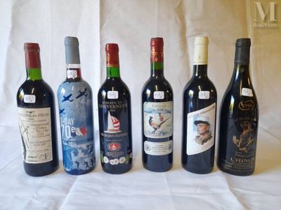 several bottles of wine are lined up on a table