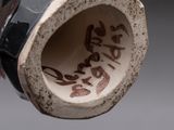 a close up of a vase with writing on it
