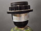 a close up of a black and green object with a passport label on it