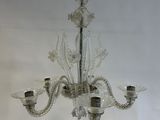 a glass chandelier hanging from a ceiling in a room